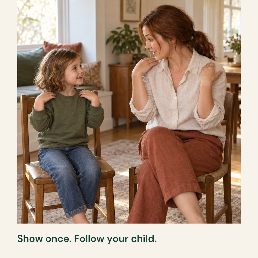 Mother and child touch their shoulders while seated and looking at each other.