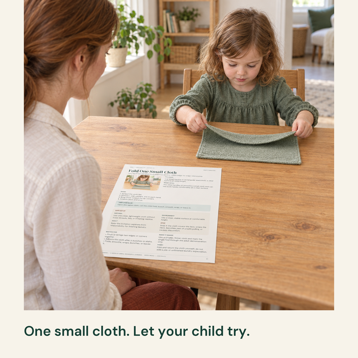 Child folds a small cloth while mother watches beside the activity guide.